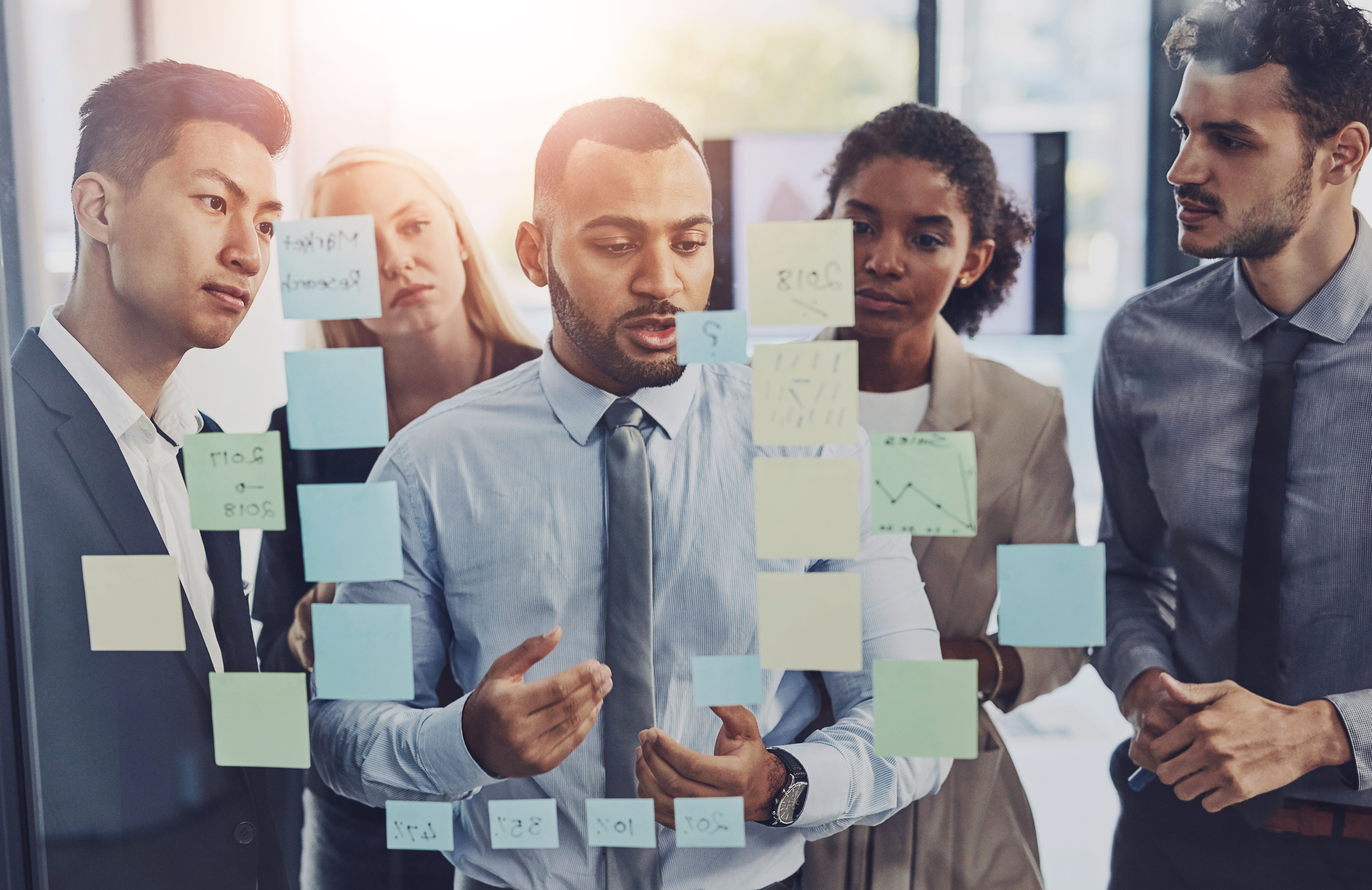 Collaboration, planning and window with business people in workshop at office for upskill development. Conversation, glass and meeting with employee team in corporate workplace for strategy or vision.